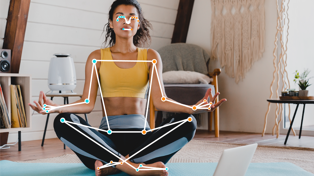 A woman in a meditative pose. Her pose is highlighted with a wireframe that indicates the positioning of her limbs and torso